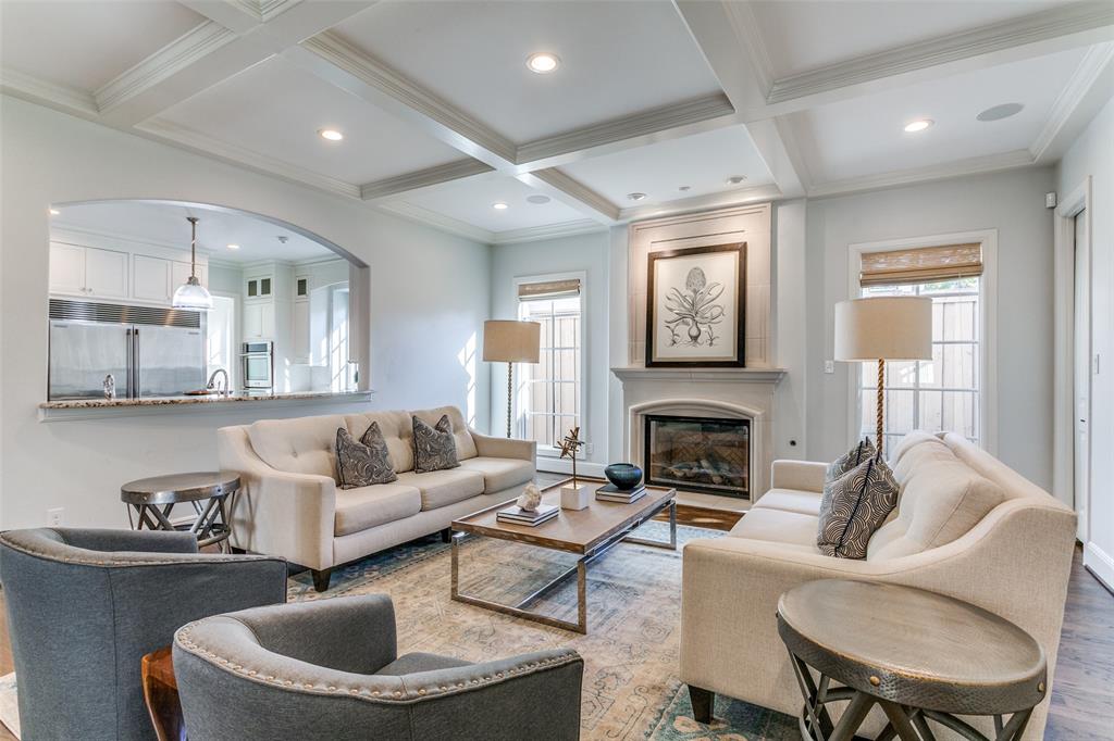 a living room with furniture a fireplace and a window