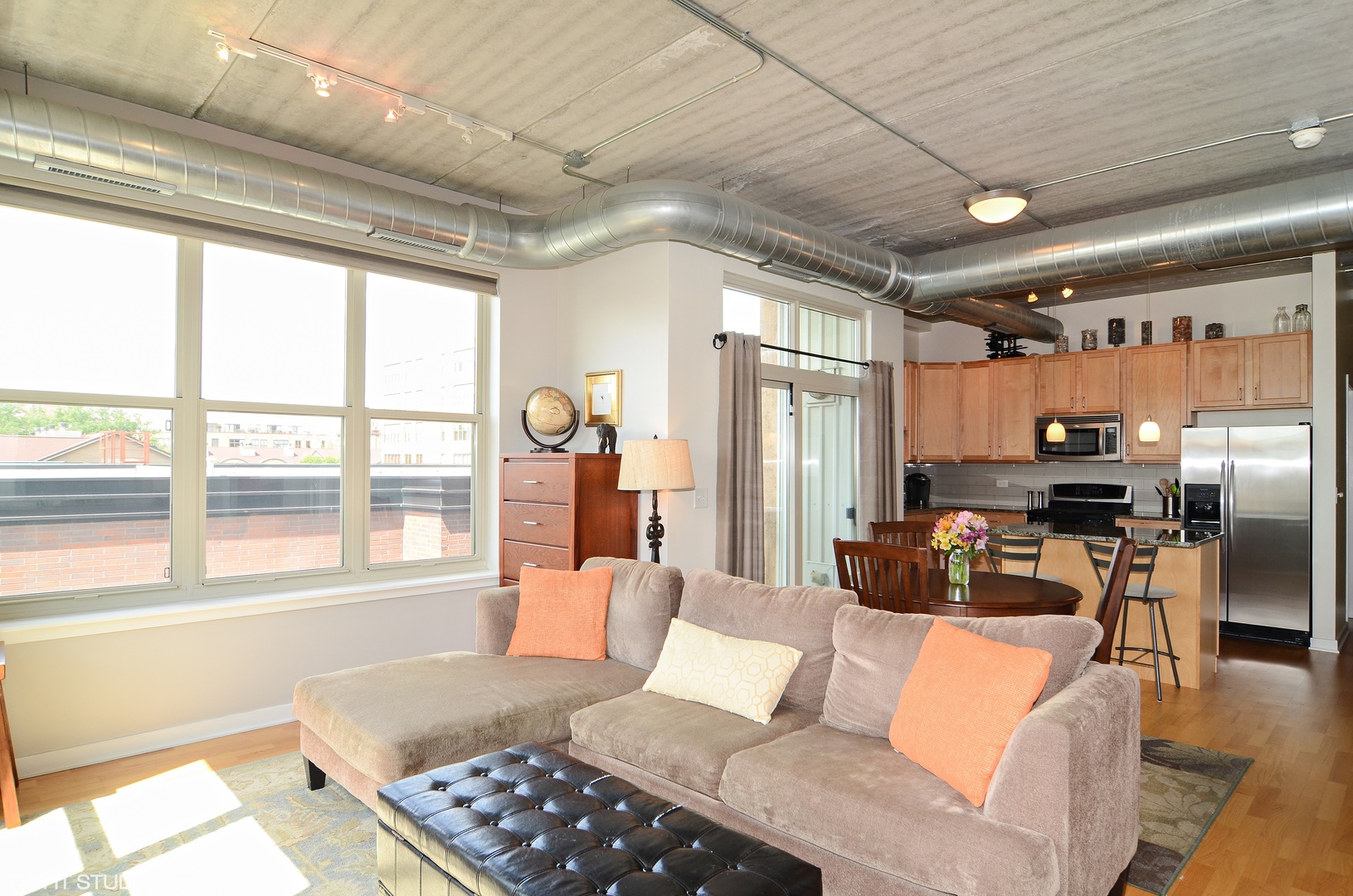 1228 West Monroe Street, Unit 401 Chicago, IL 60607 - Photo 2 of 8 a living room with furniture a large window with kitchen view