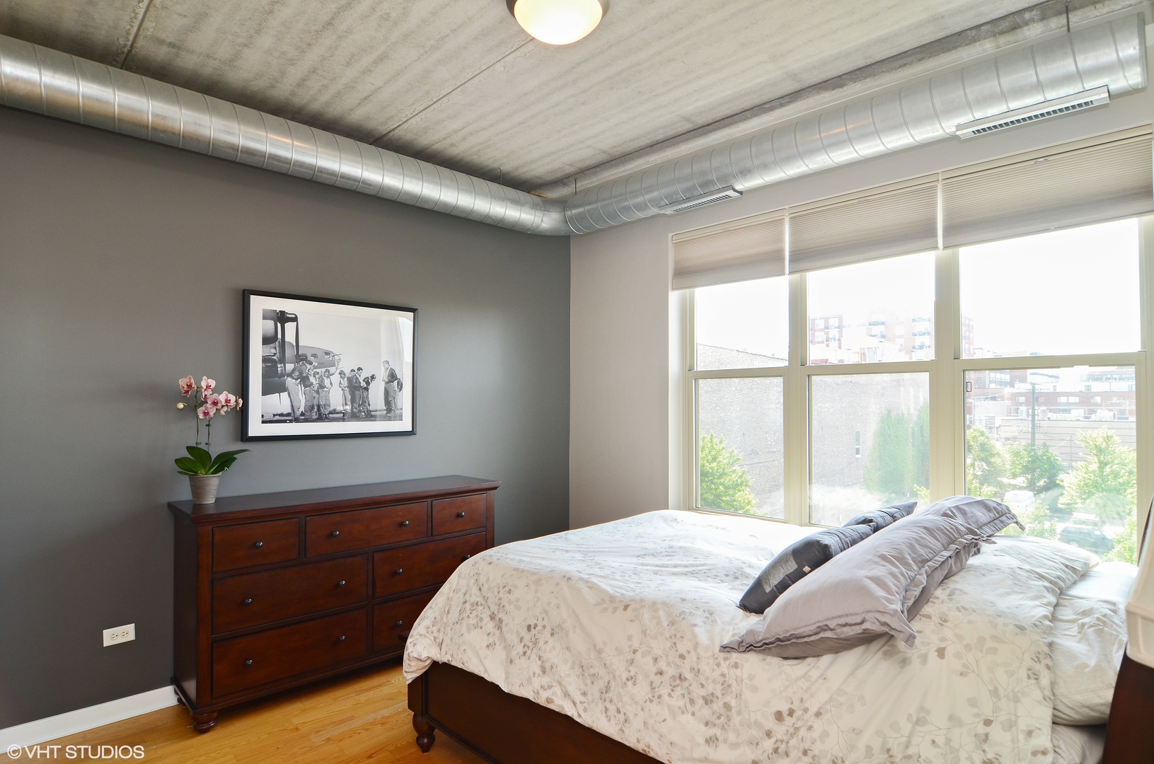 1228 West Monroe Street, Unit 401 Chicago, IL 60607 - Photo 4 of 8 a bedroom with a bed and a window