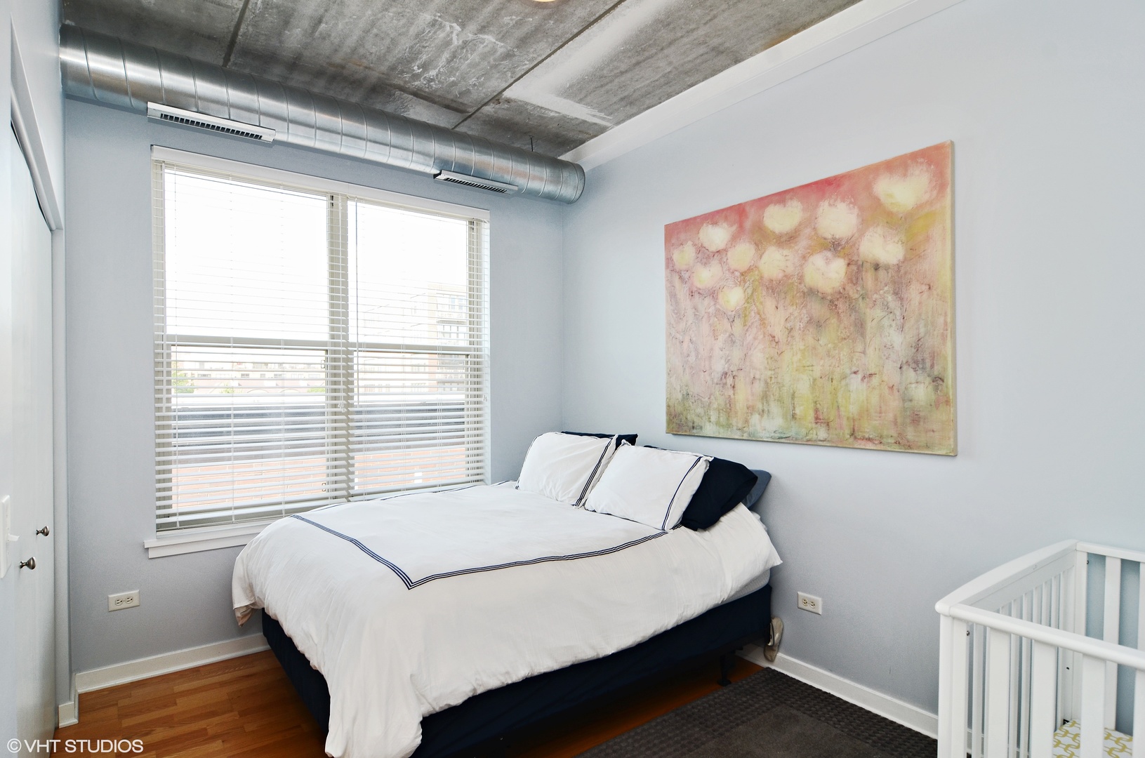 1228 West Monroe Street, Unit 401 Chicago, IL 60607 - Photo 6 of 8 a bedroom with a bed and a window