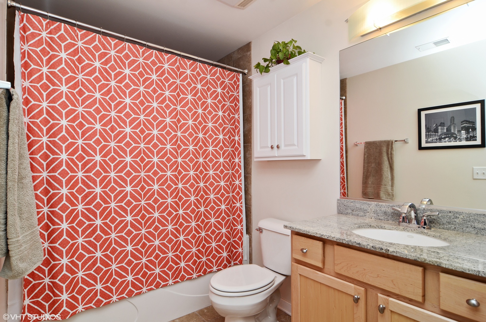 1228 West Monroe Street, Unit 401 Chicago, IL 60607 - Photo 7 of 8 a bathroom with a granite countertop toilet a sink and a mirror