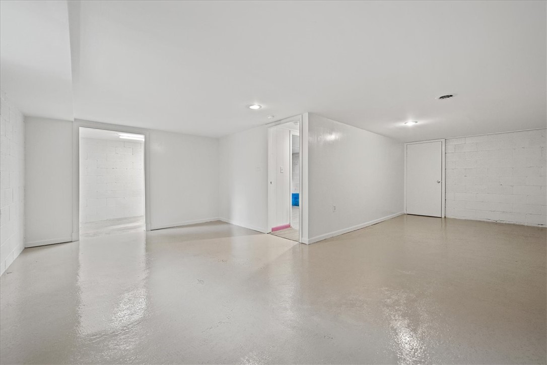 16 State Rd S-23-429 Greenville, SC 29609 - Photo 25 of 34 Clean painted concrete floors and recessed lighting define this versatile lower level area.
