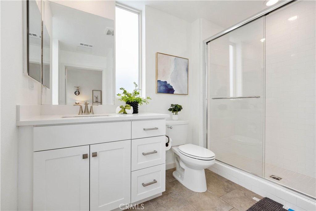 143 Bowery Irvine, CA 92612 - Photo 16 of 32 a bathroom with a sink a toilet and shower