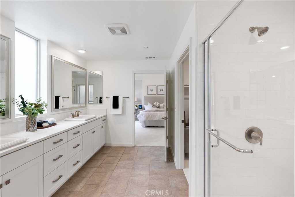 143 Bowery Irvine, CA 92612 - Photo 21 of 32 a bathroom with a double vanity sink mirror and shower
