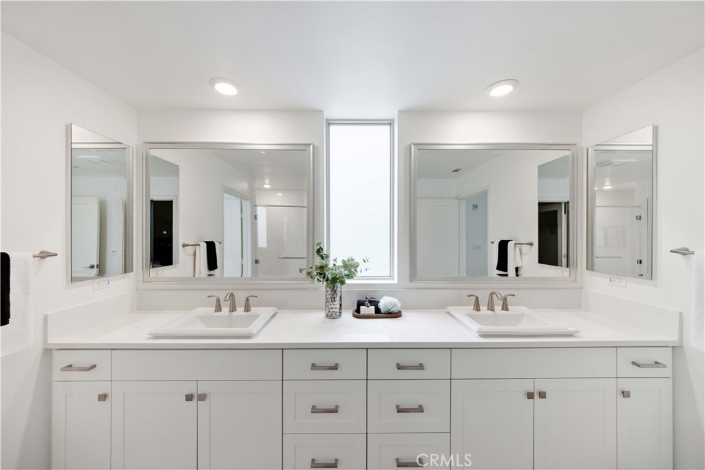 143 Bowery Irvine, CA 92612 - Photo 22 of 32 a bathroom with double sink and a mirror