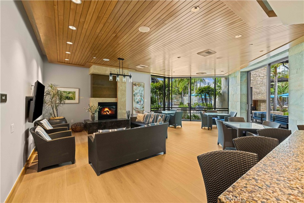 143 Bowery Irvine, CA 92612 - Photo 26 of 32 a living room with furniture large windows and a flat screen tv