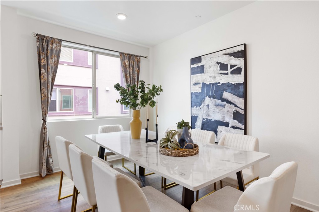 143 Bowery Irvine, CA 92612 - Photo 7 of 32 a view of a dining room and livingroom with furniture wooden floor and a window
