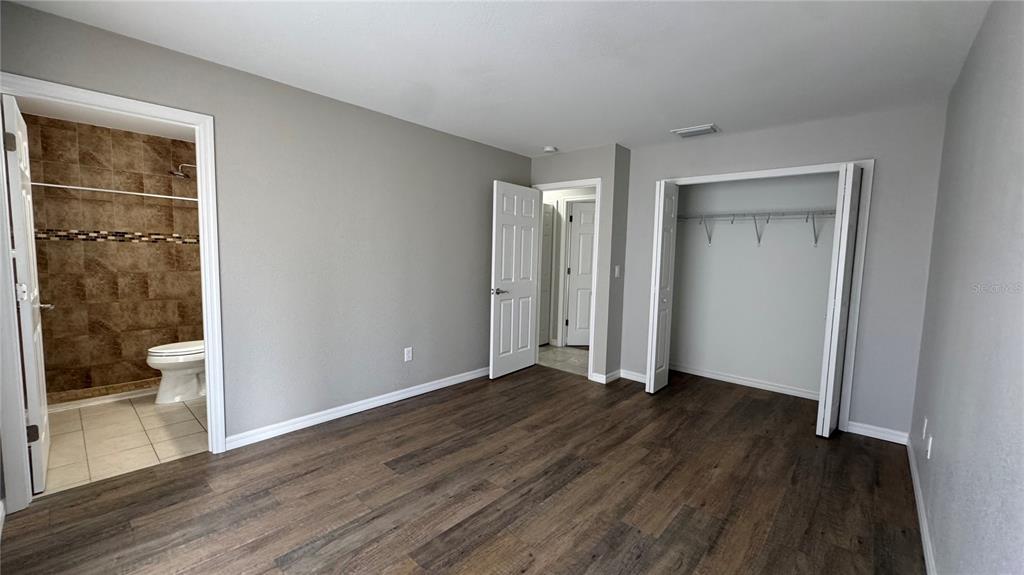 4318 Mongite Road North Port, FL 34287 - Photo 12 of 18 a view of an empty room with wooden floor and a window