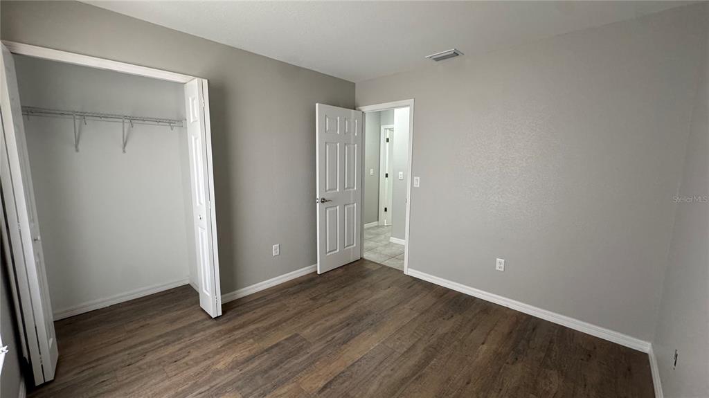 4318 Mongite Road North Port, FL 34287 - Photo 18 of 18 an empty room with wooden floor & closet area