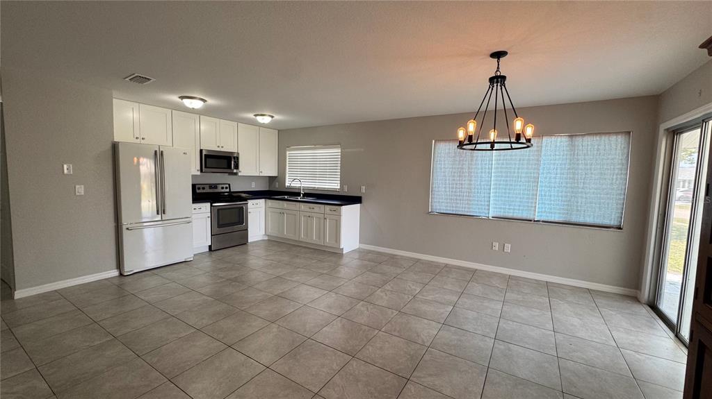 4318 Mongite Road North Port, FL 34287 - Photo 4 of 18 a view of a kitchen with a sink and chandelier