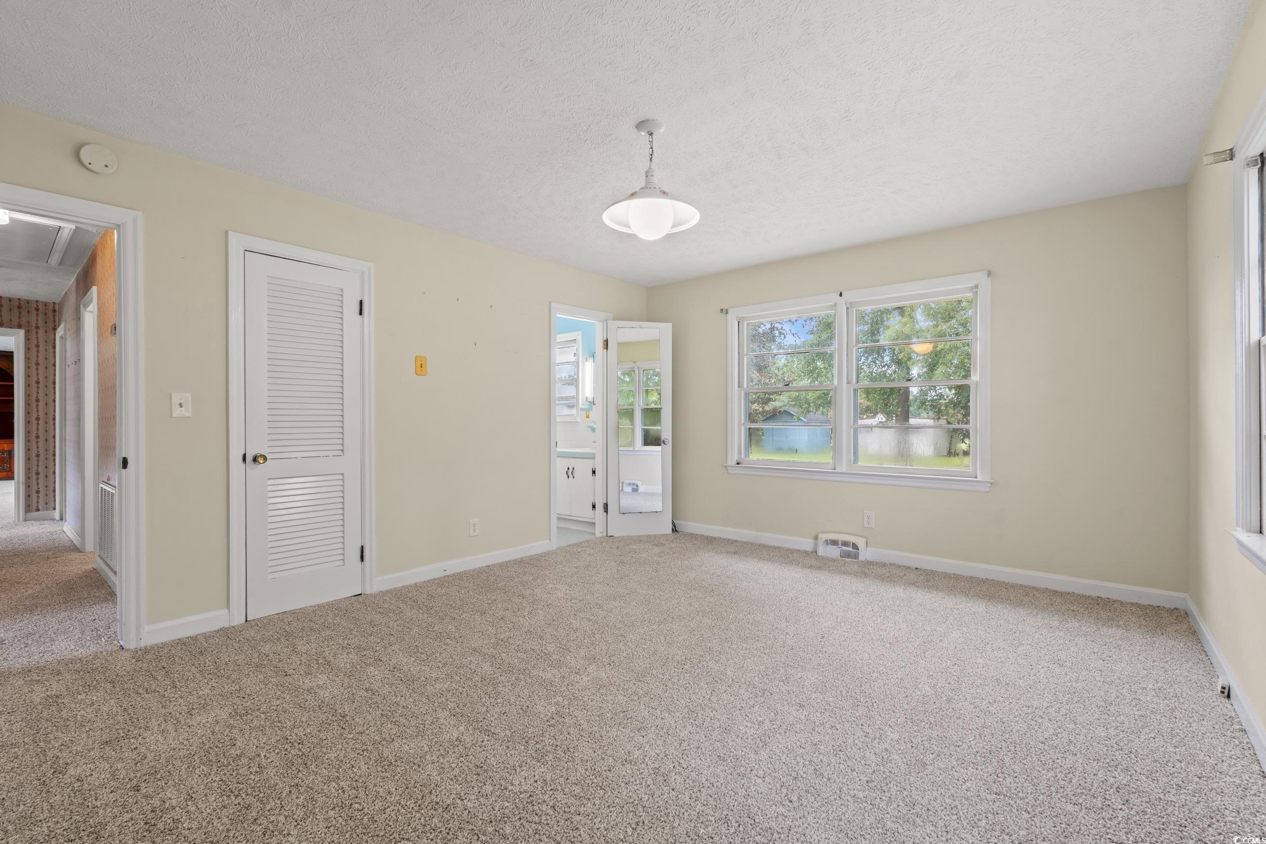 4155 Pinewood Drive Mullins, SC 29574 - Photo 10 of 33 Unfurnished bedroom featuring carpet flooring and a textured ceiling