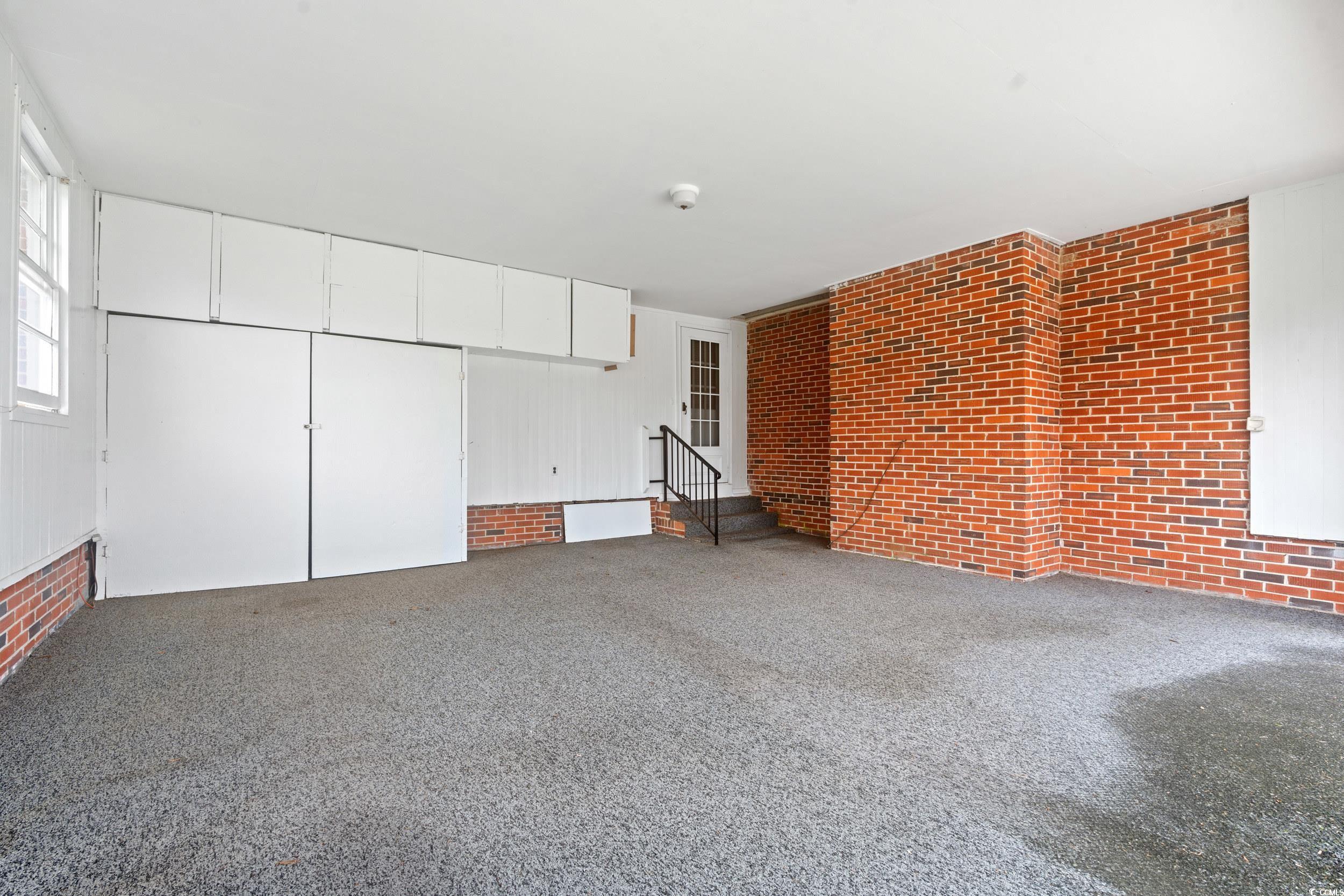 4155 Pinewood Drive Mullins, SC 29574 - Photo 18 of 33 Carpeted spare room featuring brick wall