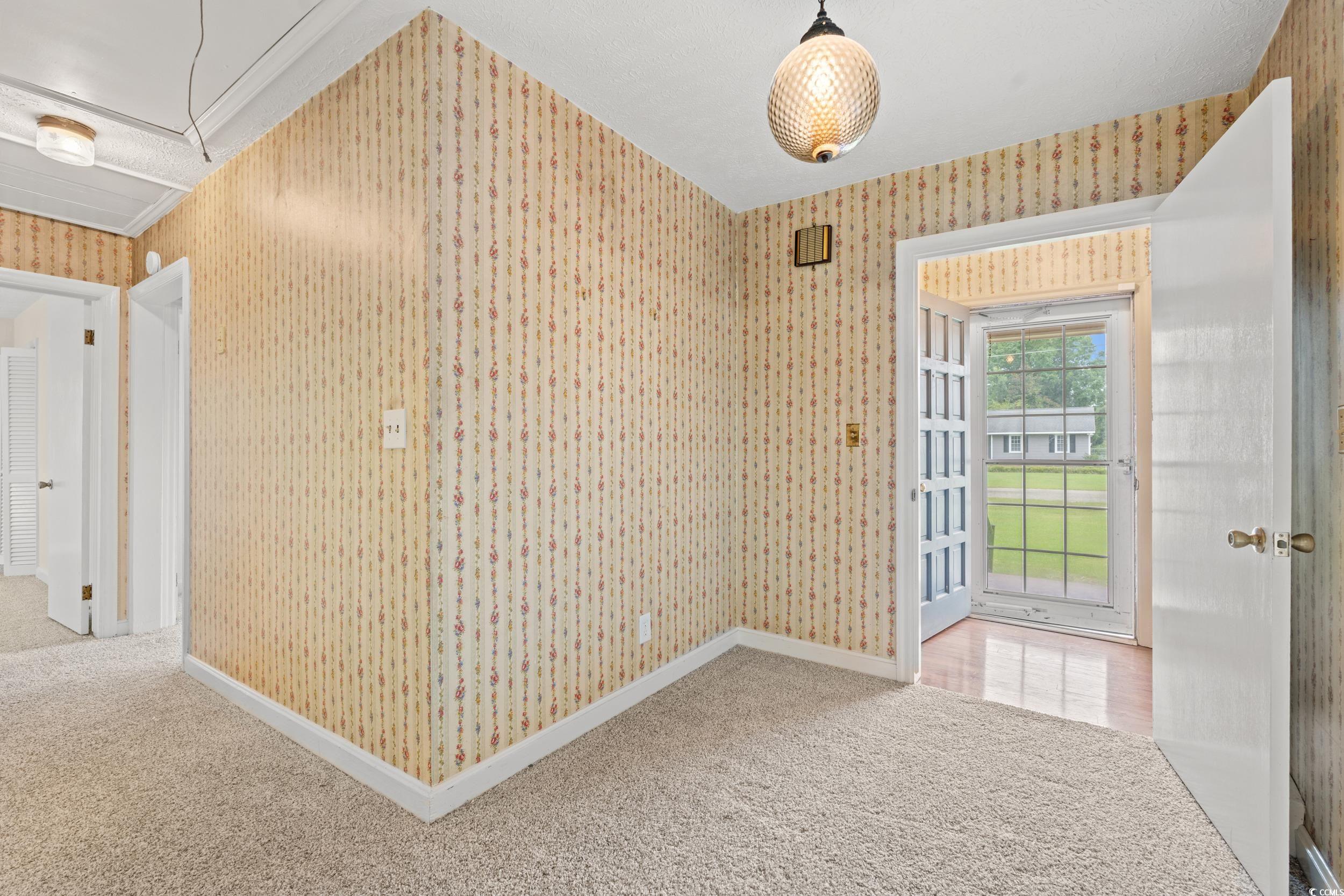 4155 Pinewood Drive Mullins, SC 29574 - Photo 2 of 33 Unfurnished room with attic access, wallpapered walls, and carpet floors