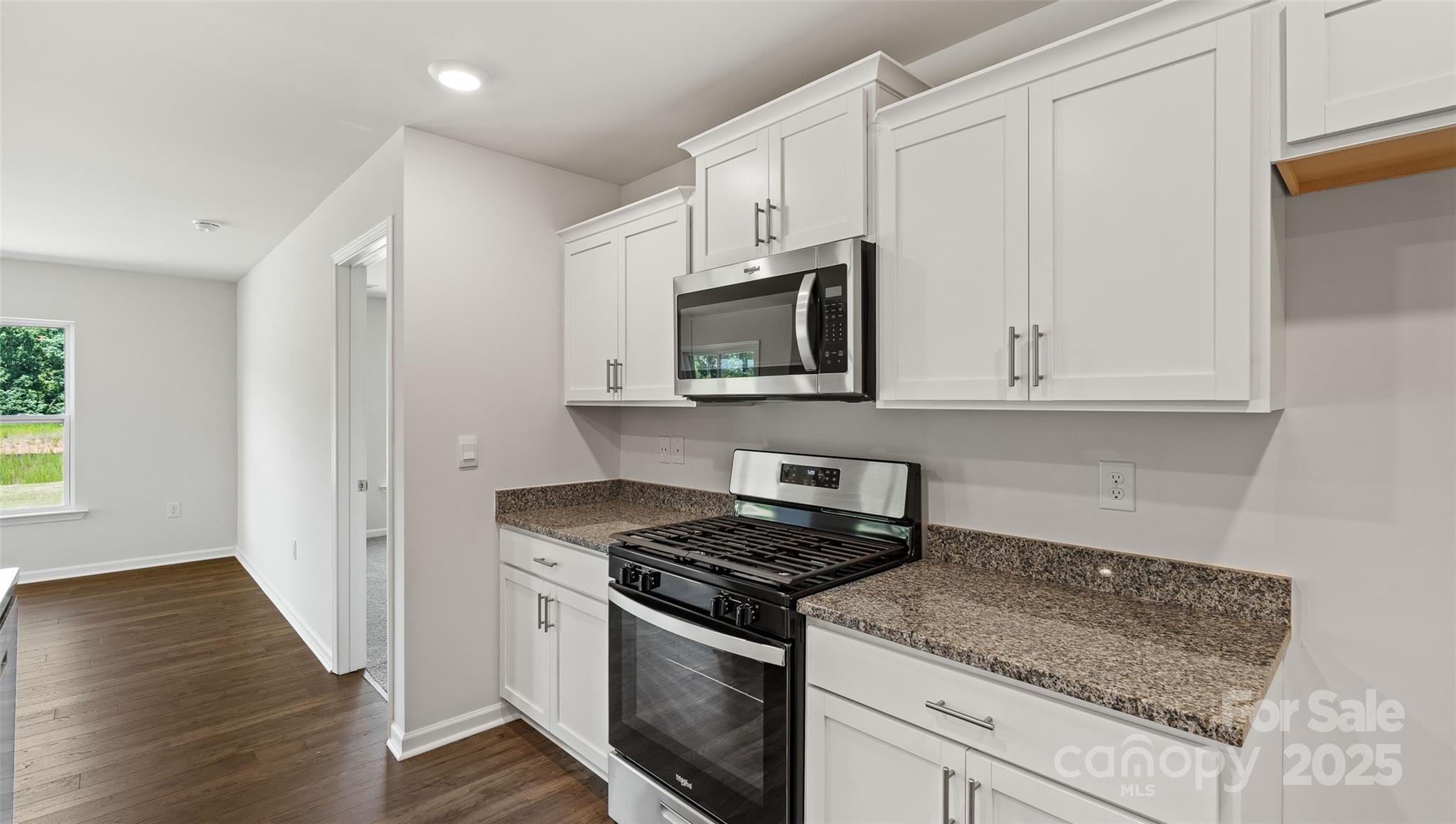 212 Callie River Clyde, NC 28721 - Photo 4 of 25 a kitchen with stainless steel appliances granite countertop white cabinets granite counter tops and a stove