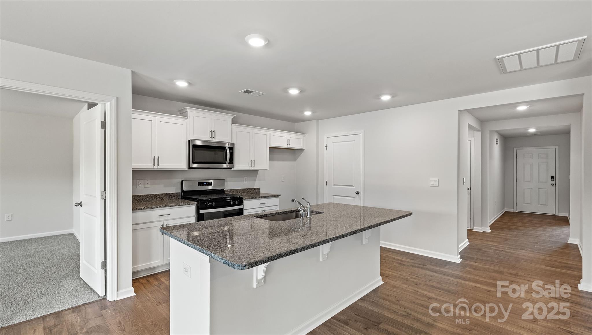 212 Callie River Clyde, NC 28721 - Photo 6 of 25 a kitchen with stainless steel appliances granite countertop a sink and microwave