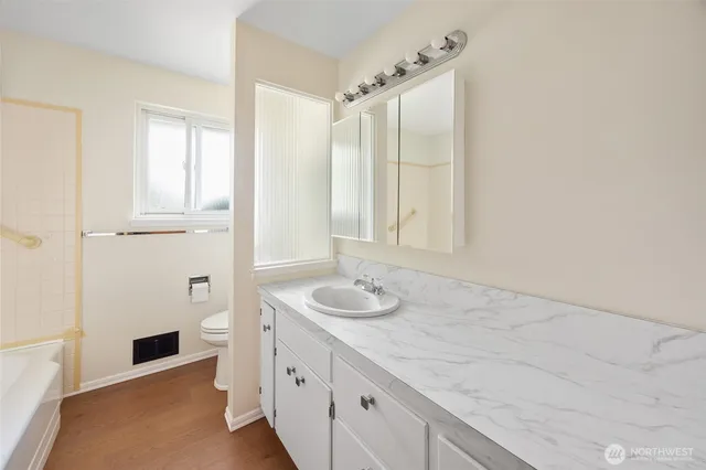 a bathroom with a granite countertop sink and a mirror