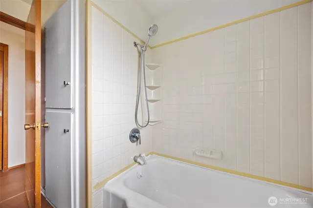 a bathroom with a bathtub and a shower