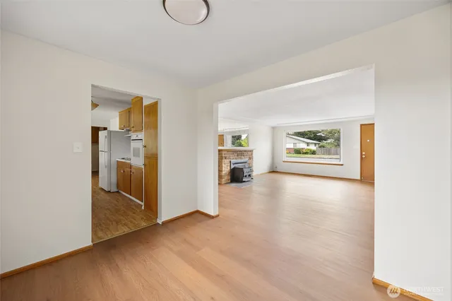 a view of a hallway with wooden floor and closet