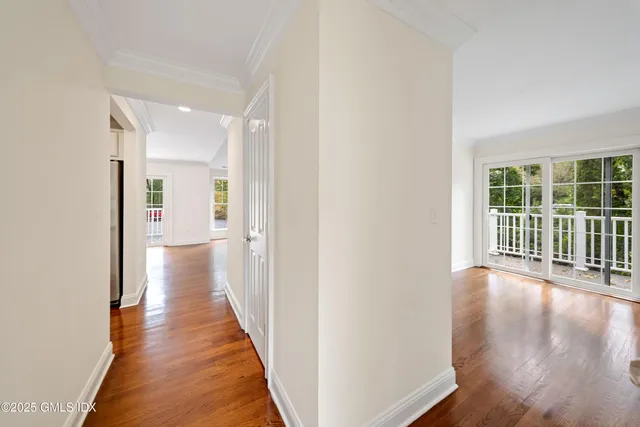 a view of a hallway with wooden floor