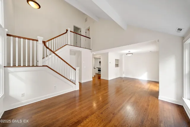 a view of an entryway with wooden floor