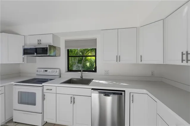 a kitchen that has a sink and a stove