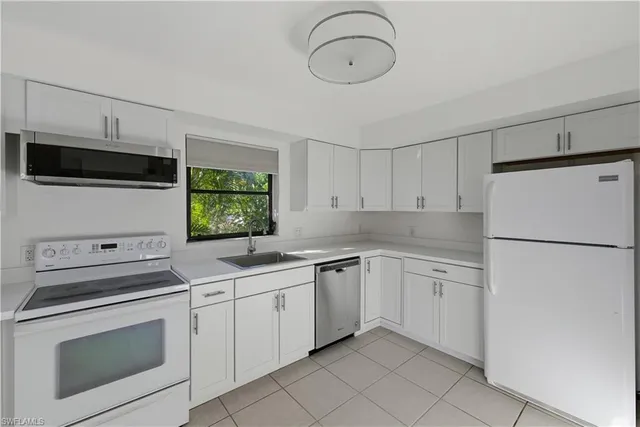 a kitchen with appliances cabinets and a sink