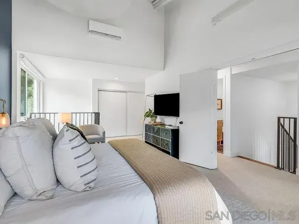 a bedroom with a bed and a flat screen tv