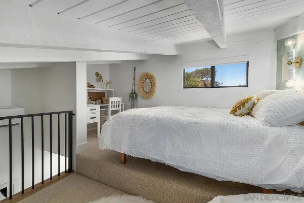 a bedroom with a large bed and a walk in closet