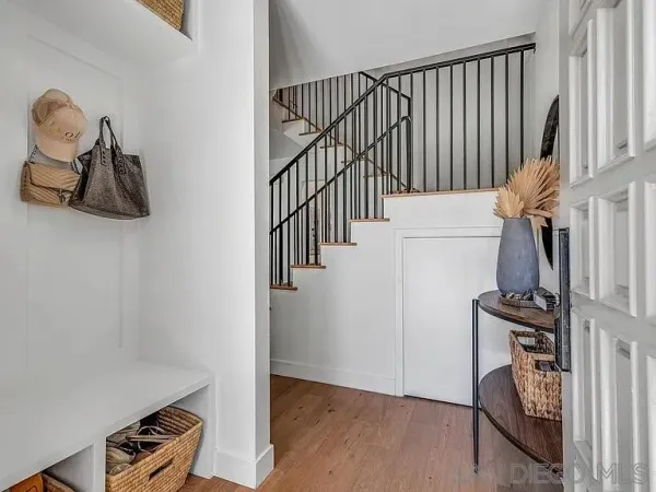 a view of hallway with wooden floor and stairs