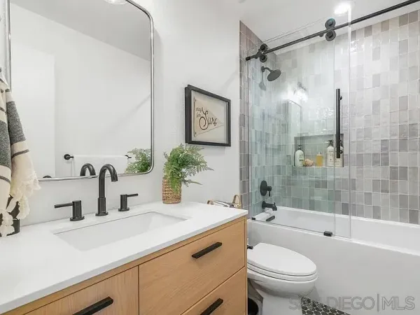 a bathroom with a shower and a sink
