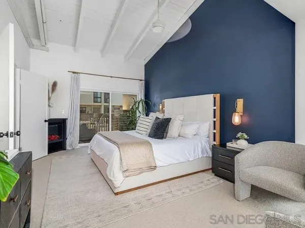 a bedroom with a bed lamp and a fireplace