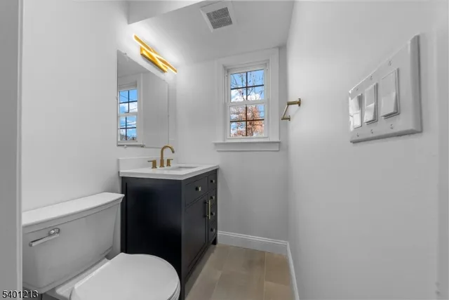 a view of a hallway with wooden floor and stairs