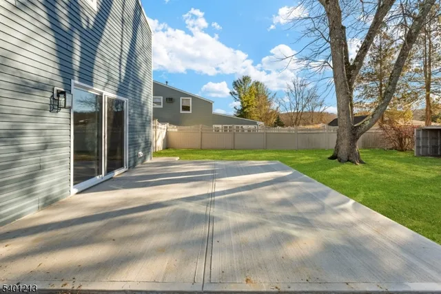 a view of yard with swimming pool and green space