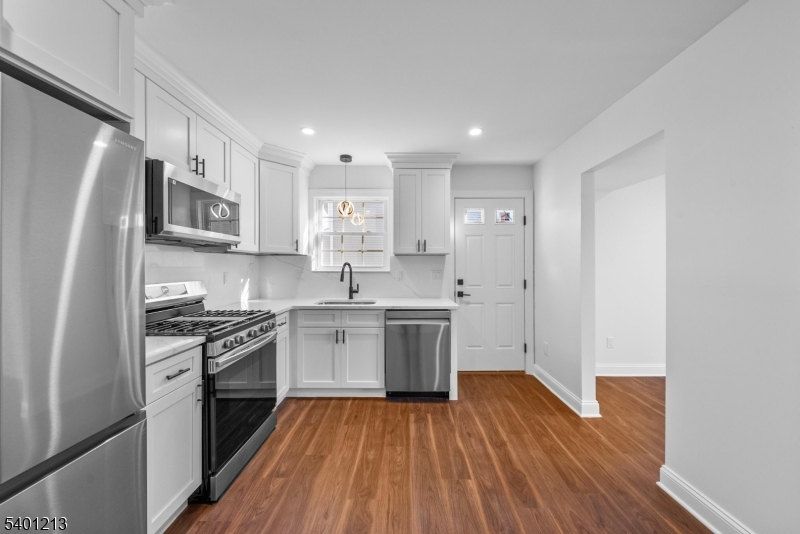 14 Harwich Road Flanders, NJ 07836 - Photo 8 of 34 a kitchen with a sink wooden floor and stainless steel appliances