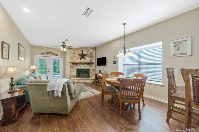 a dining room with furniture window and wooden floor