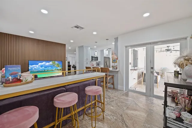 a living room kitchen with furniture and a view of kitchen