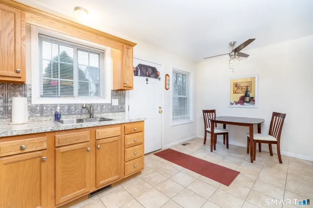 a spacious kitchen with a dining table chairs and a refrigerator