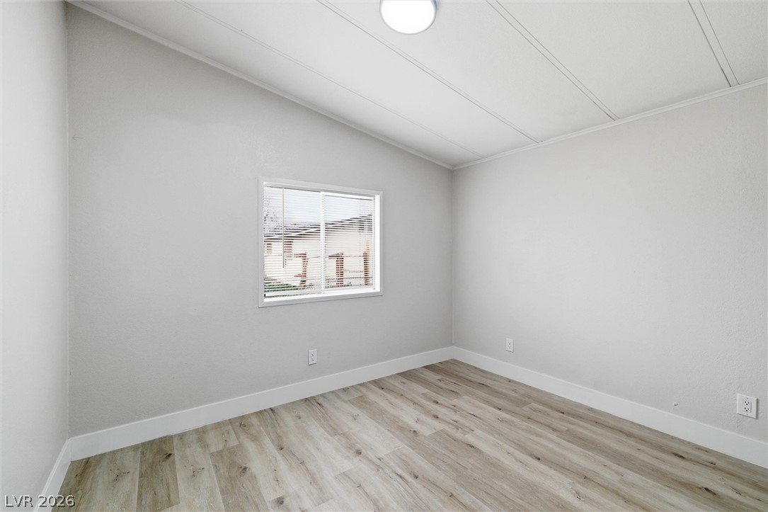3940 Point Drive Pahrump, NV 89060 - Photo 25 of 35 A well-lit bedroom featuring durable vinyl plank flooring and a clean, modern aesthetic.