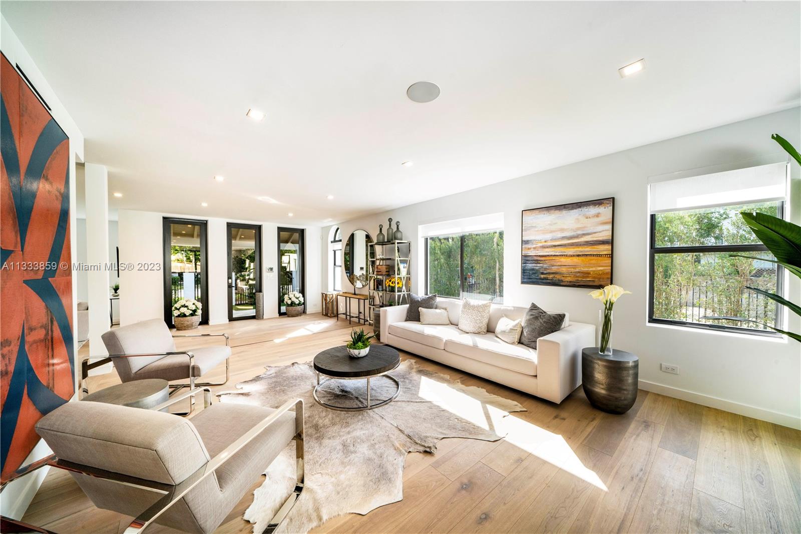 5334 Pine Tree Drive Miami Beach, FL 33140 - Photo 12 of 42 a living room with furniture and a large window