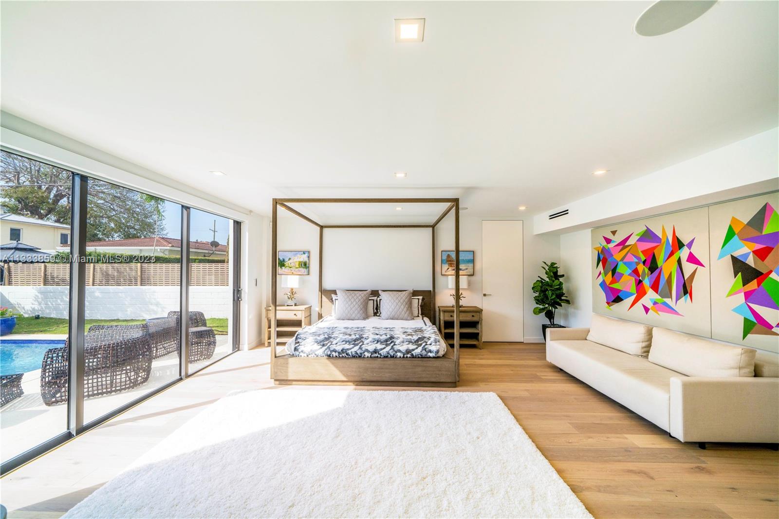 5334 Pine Tree Drive Miami Beach, FL 33140 - Photo 14 of 42 a bedroom with furniture and a large window