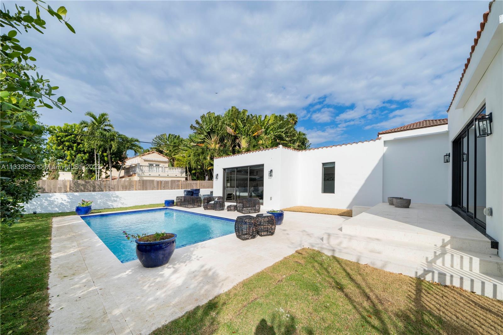 5334 Pine Tree Drive Miami Beach, FL 33140 - Photo 22 of 42 a view of swimming pool with outdoor seating and plants