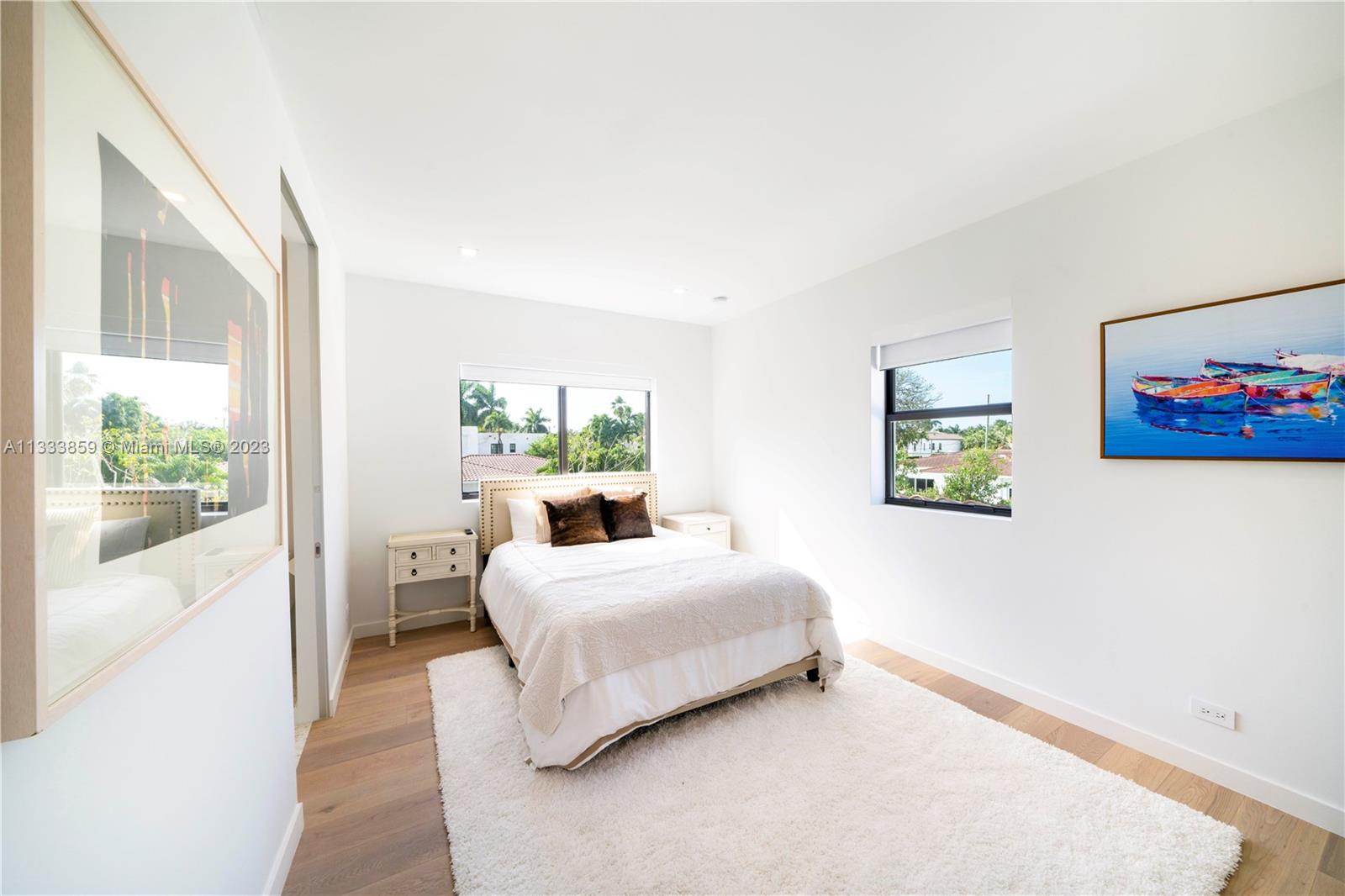 5334 Pine Tree Drive Miami Beach, FL 33140 - Photo 26 of 42 a bedroom with a bed and a painting on the wall