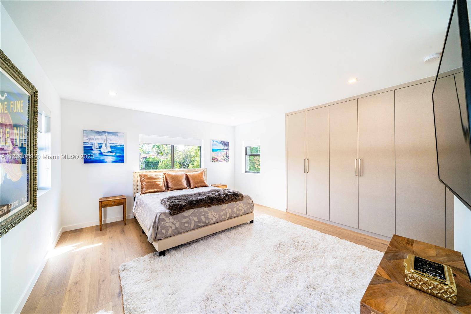 5334 Pine Tree Drive Miami Beach, FL 33140 - Photo 30 of 42 a spacious bedroom with a bed and a large window