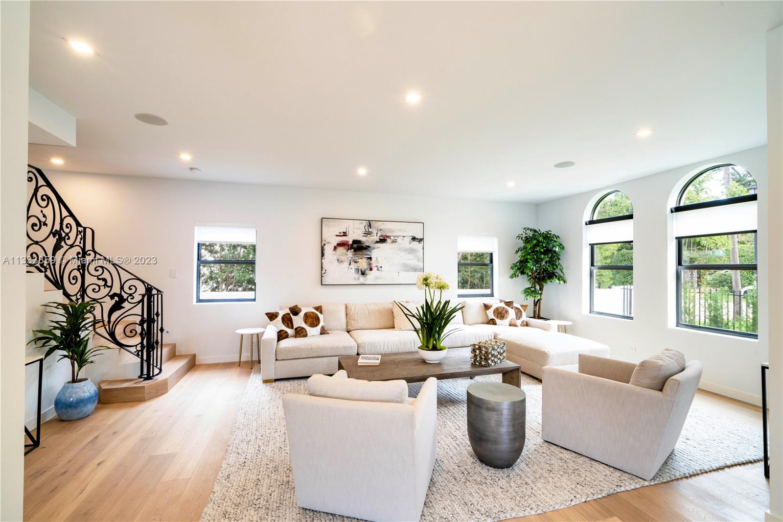 5334 Pine Tree Drive Miami Beach, FL 33140 - Photo 3 of 42 a living room with furniture and a flat screen tv