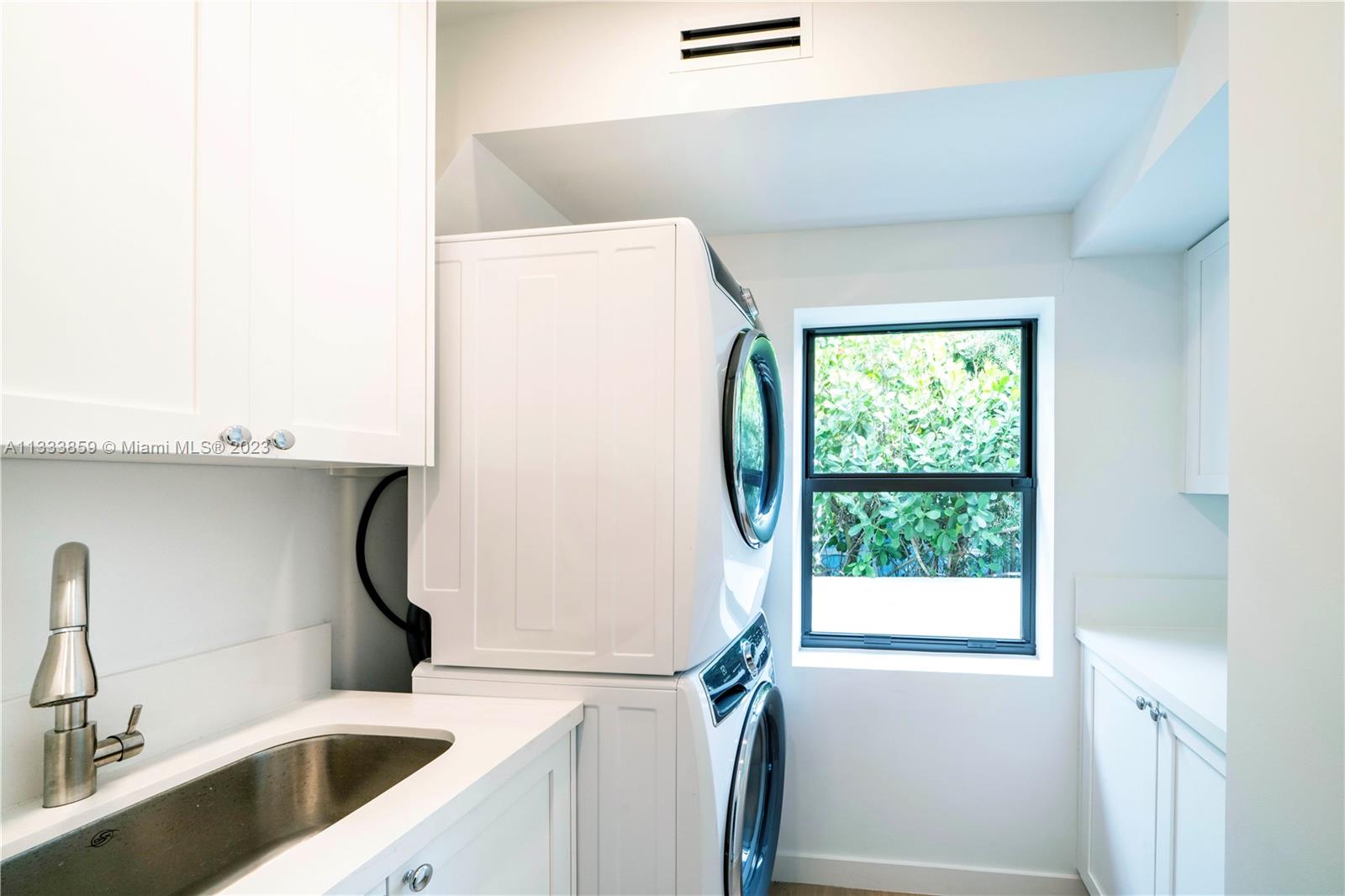 5334 Pine Tree Drive Miami Beach, FL 33140 - Photo 32 of 42 a bathroom with a sink a toilet and a window