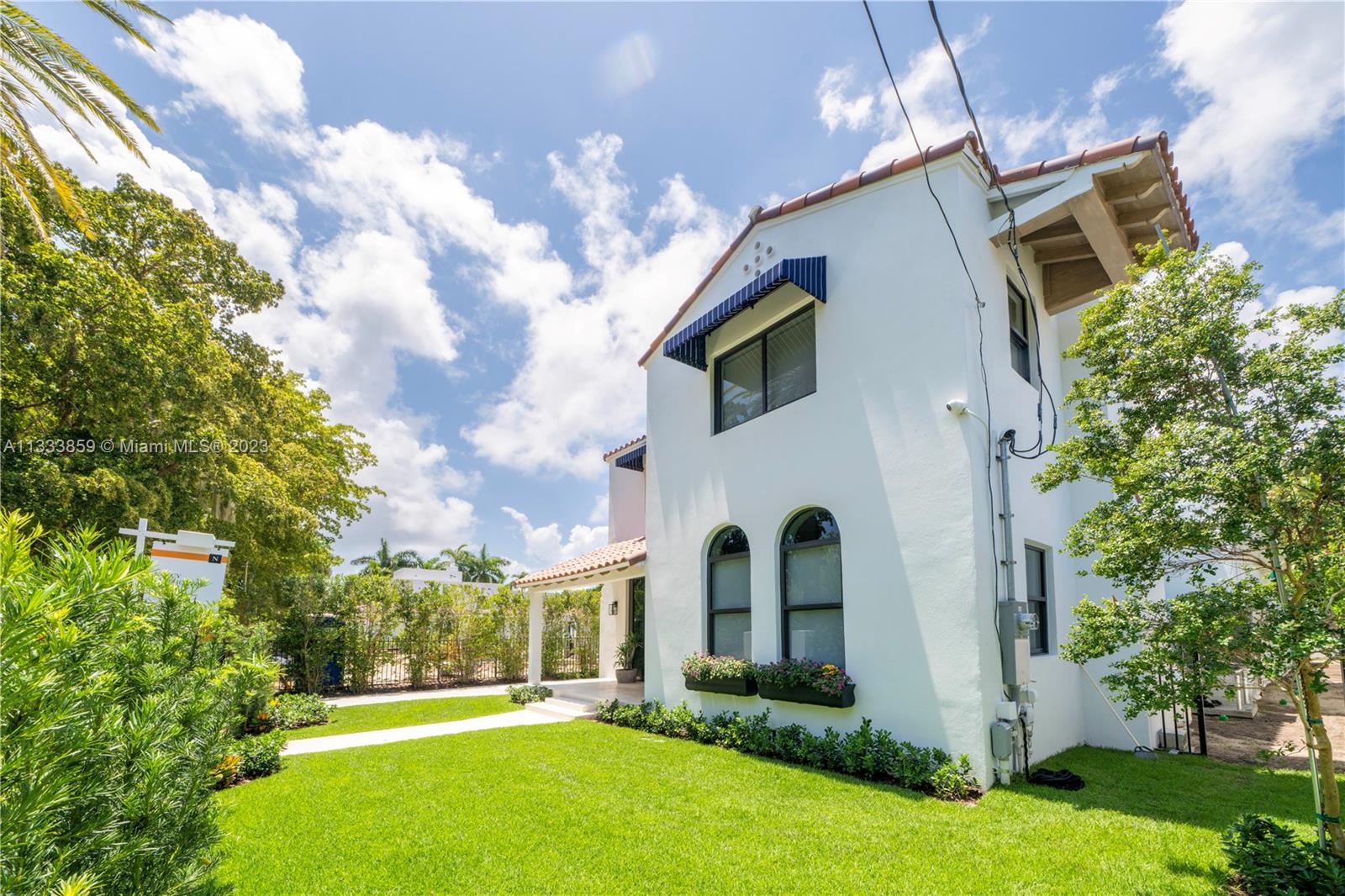 5334 Pine Tree Drive Miami Beach, FL 33140 - Photo 35 of 42 a front view of a house with garden
