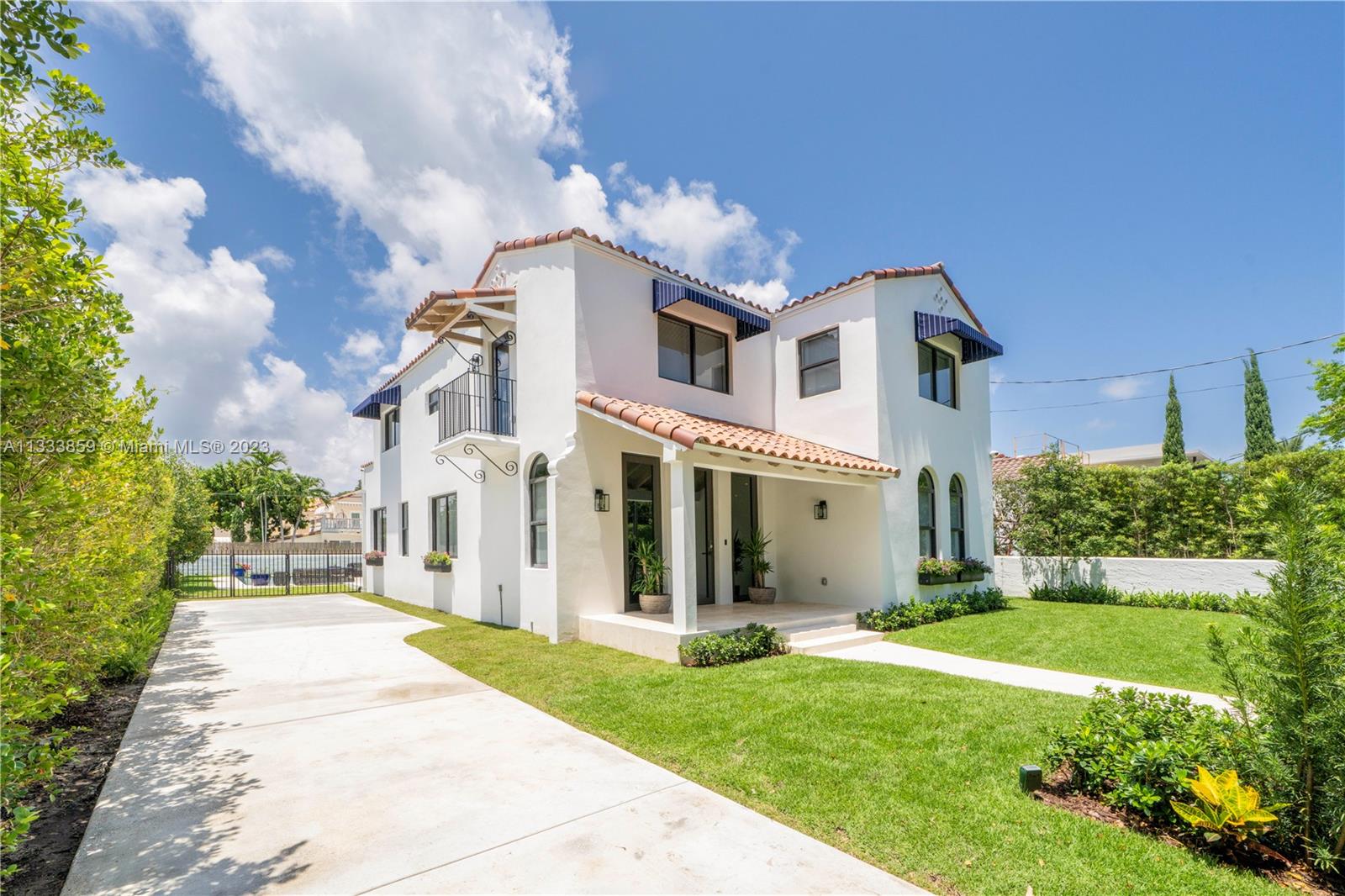 5334 Pine Tree Drive Miami Beach, FL 33140 - Photo 36 of 42 a front view of a house with a yard
