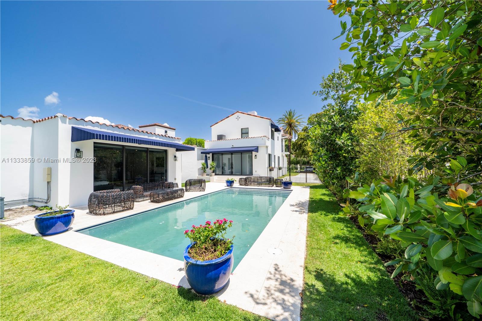 5334 Pine Tree Drive Miami Beach, FL 33140 - Photo 37 of 42 a view of a house with swimming pool and porch with furniture