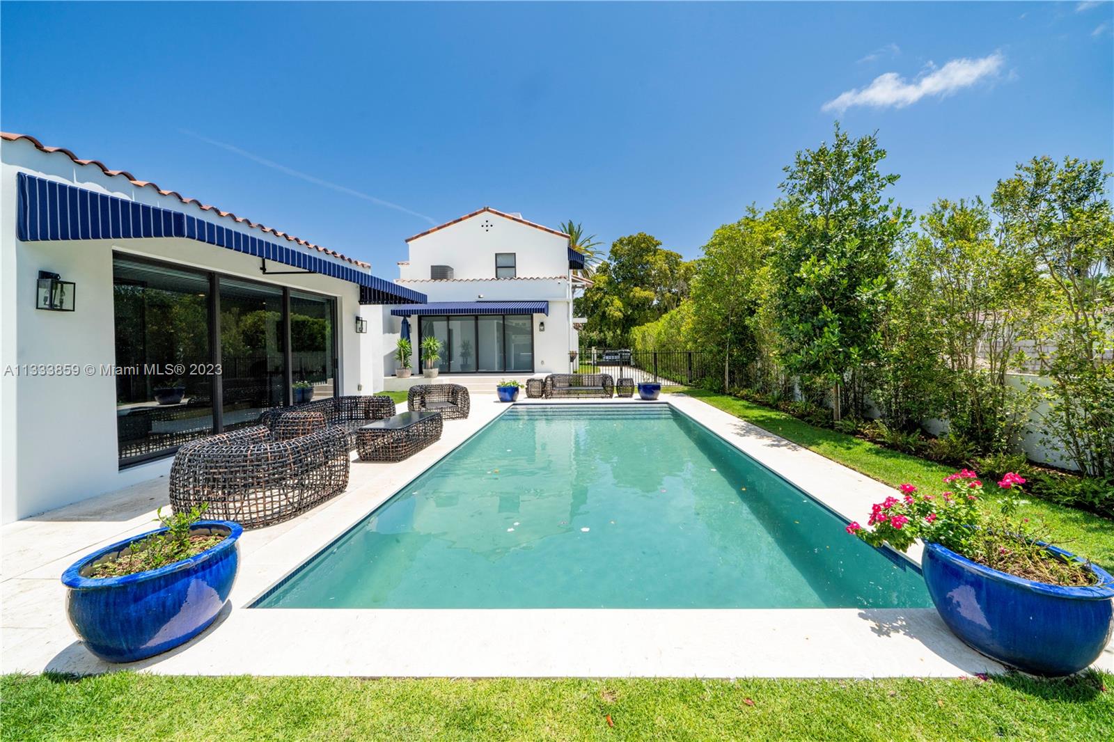 5334 Pine Tree Drive Miami Beach, FL 33140 - Photo 38 of 42 a swimming pool with outdoor seating and yard