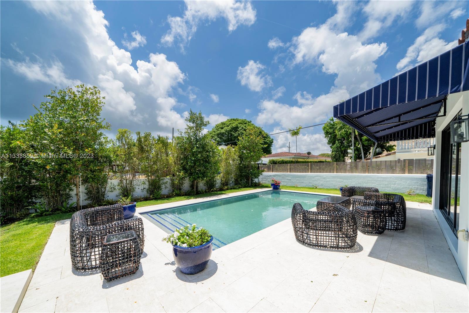 5334 Pine Tree Drive Miami Beach, FL 33140 - Photo 41 of 42 a view of a patio with couches table and chairs and potted plants